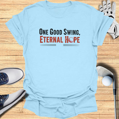 Light blue t-shirt with "One Good Swing, Eternal Hope" and golf imagery.