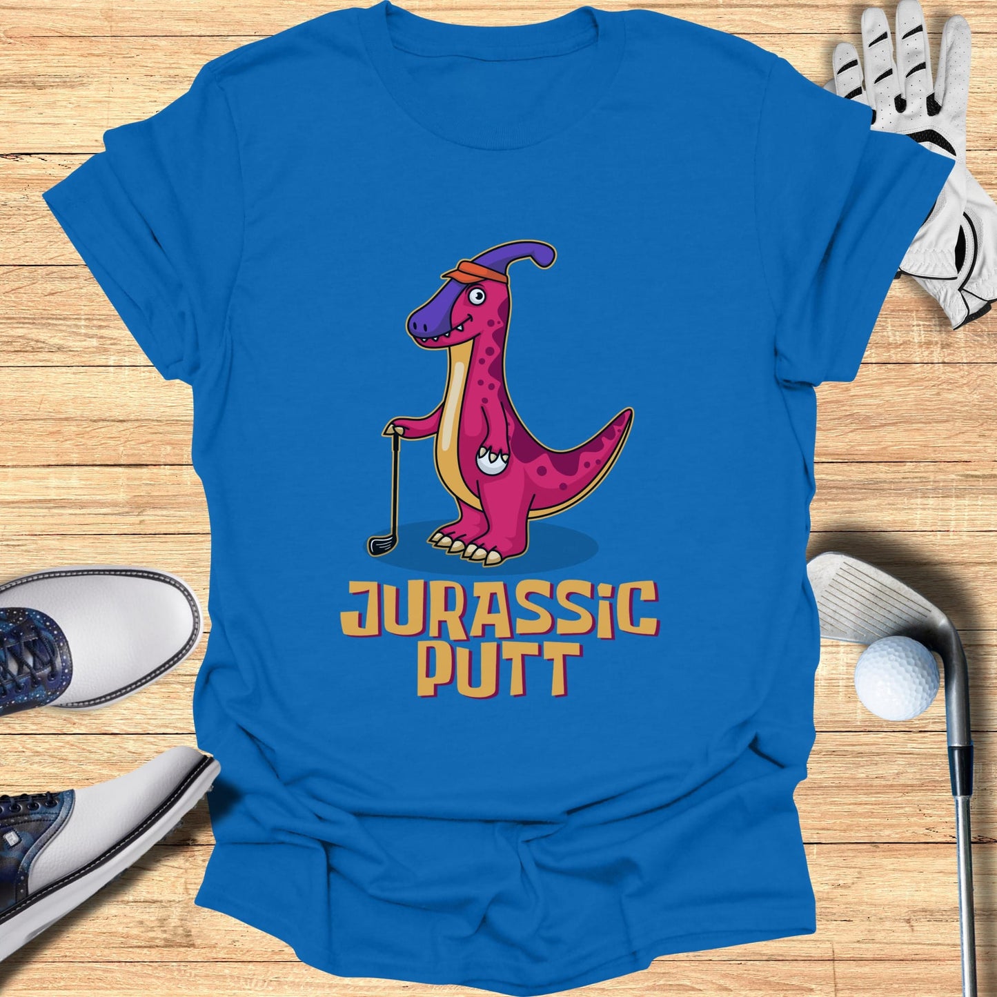 Cartoon dinosaur in golf attire with "JURASSIC PUTT" text.