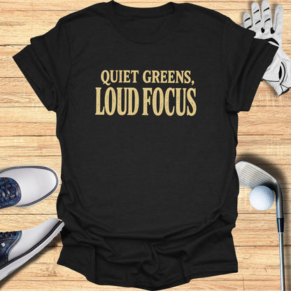 Black t-shirt with "QUIET GREENS, LOUD FOCUS" in yellow text.
