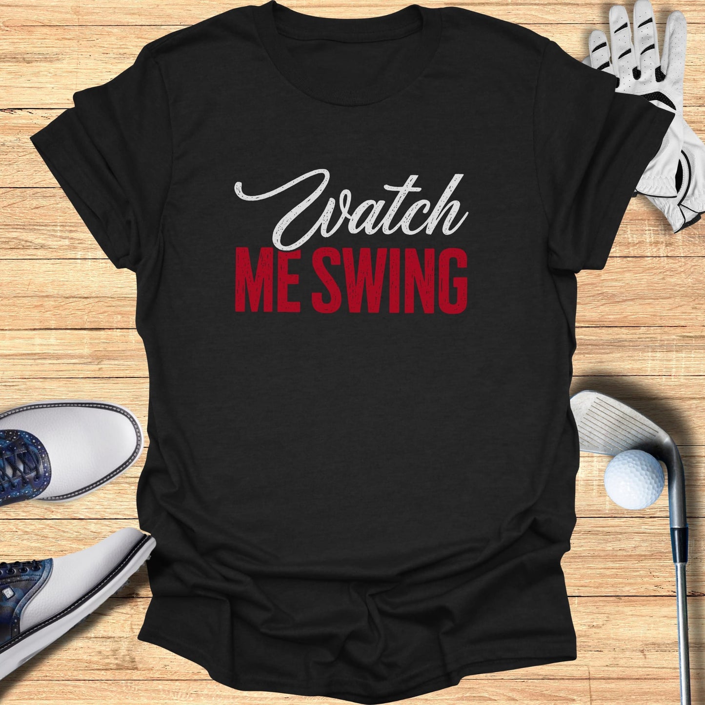 Black t-shirt with "Watch ME SWING" text, golf club, glove, and shoes.