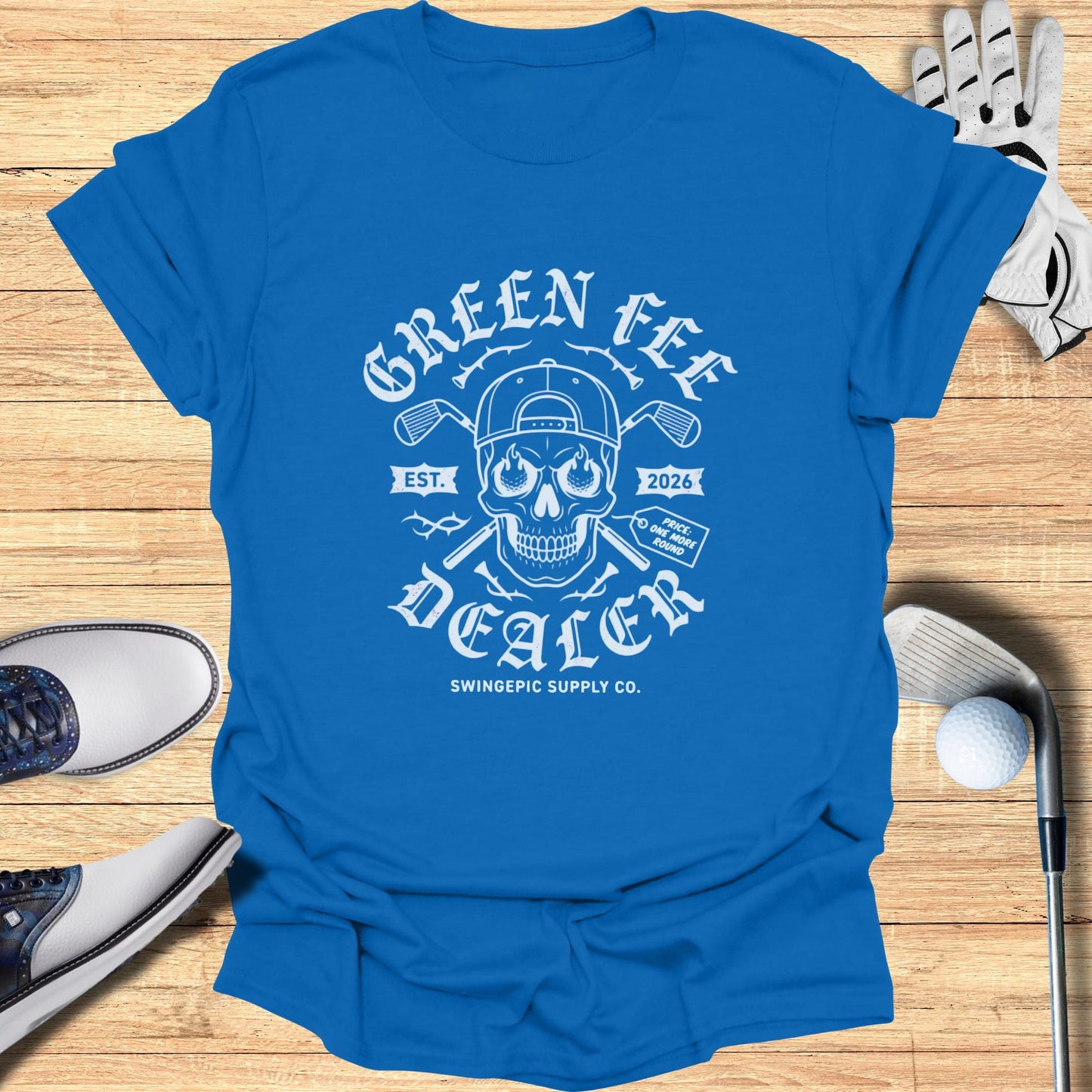Blue t-shirt with "Green Fee Dealer" skull graphic, golf clubs, and scorecard.
