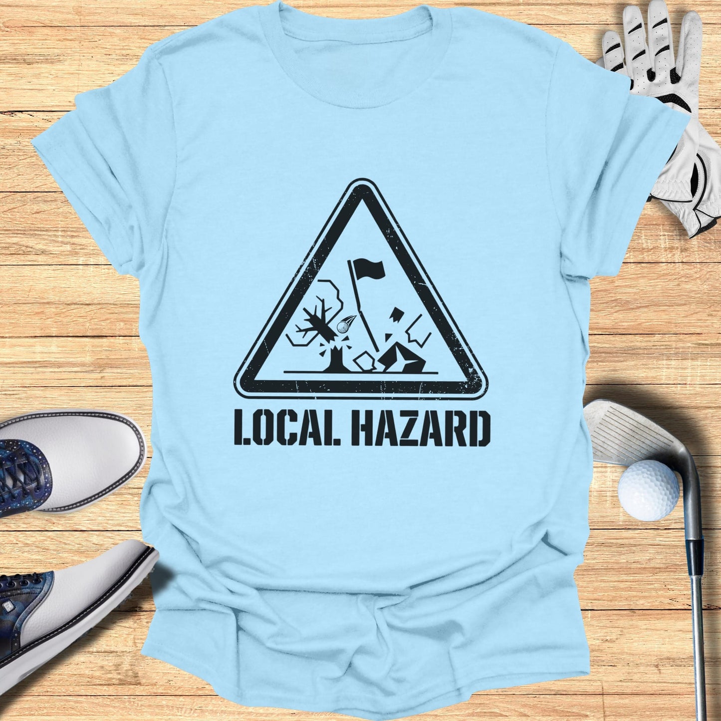 Light blue t-shirt with "Local Hazard" warning sign featuring a golf ball and tree.