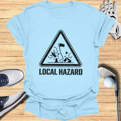 Light blue t-shirt with "Local Hazard" warning sign featuring a golf ball and tree.