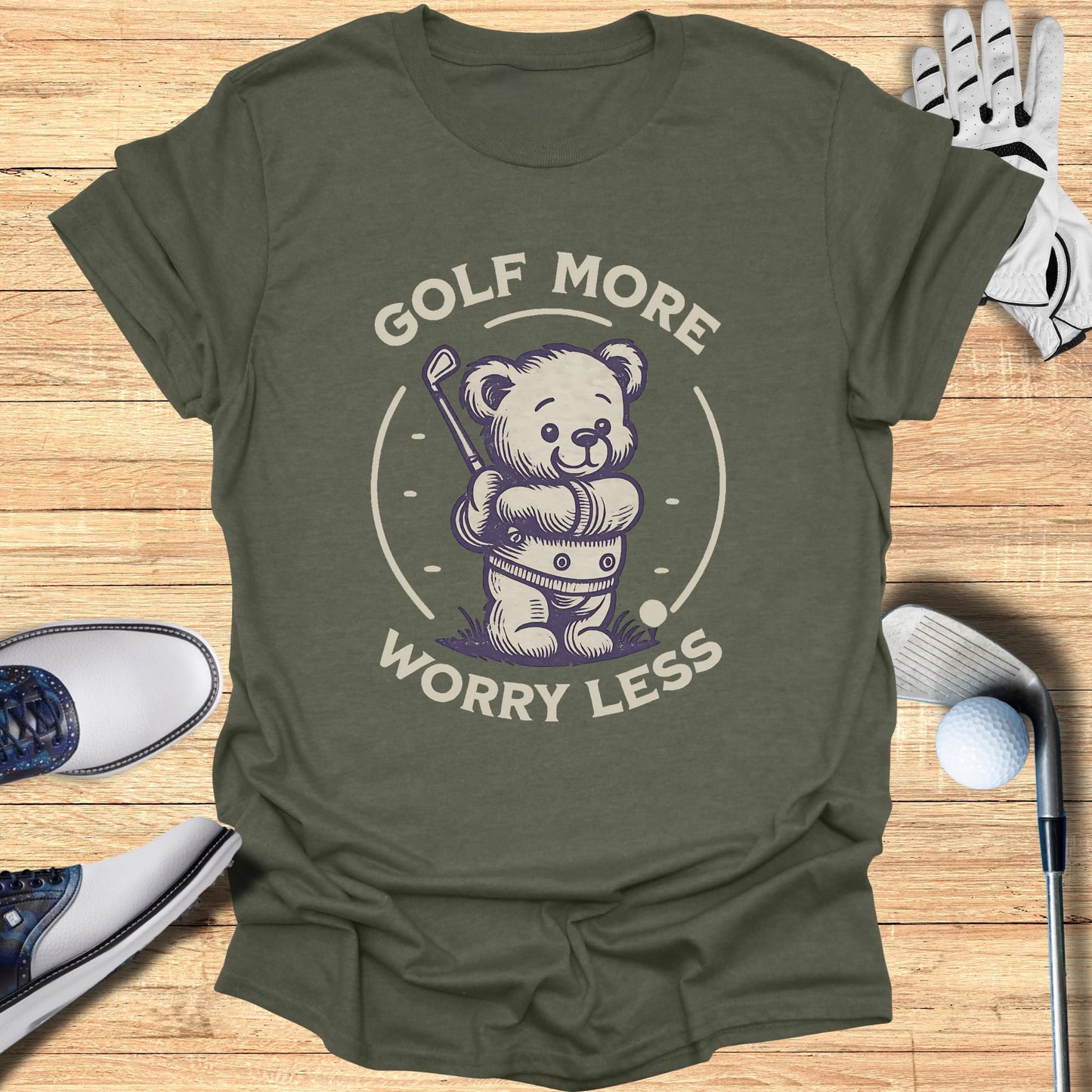 T-shirt with a cartoon bear swinging a golf club.