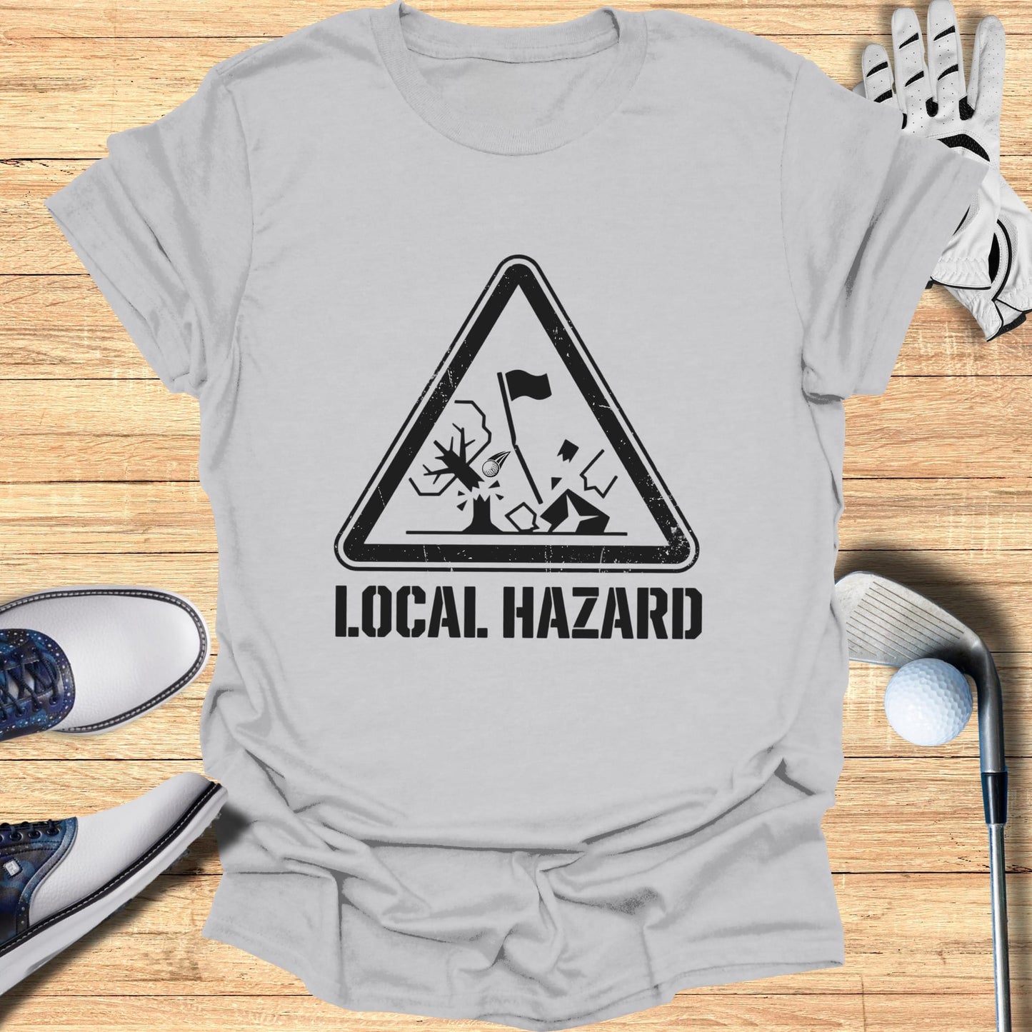 T-shirt with "LOCAL HAZARD" golf warning sign graphic.