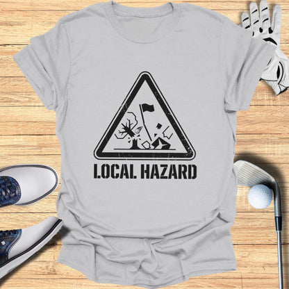T-shirt with "LOCAL HAZARD" golf warning sign graphic.