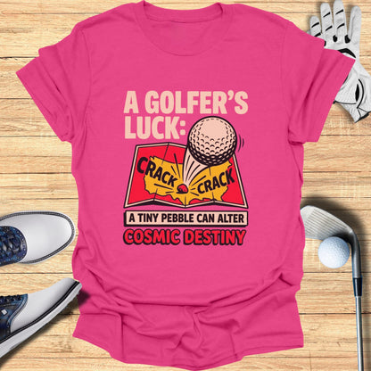 Pink t-shirt with "A Golfer's Luck: A Tiny Pebble Can Alter Cosmic Destiny" text and graphic.