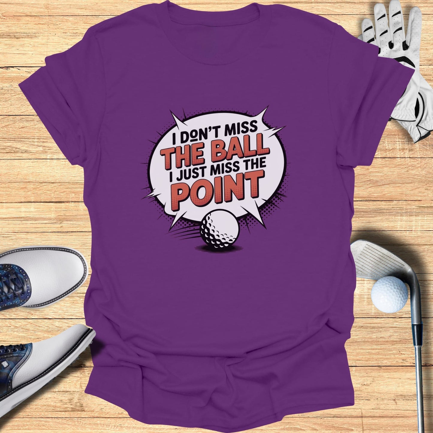 Purple t-shirt with "I don't miss the ball, I just miss the point" graphic.