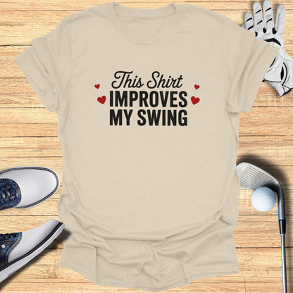 Tan t-shirt with "This Shirt Improves MY SWING" text and golf accessories.