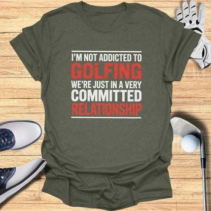 Green t-shirt with "I'm Not Addicted To Golfing We're Just In A Very Committed Relationship" text.