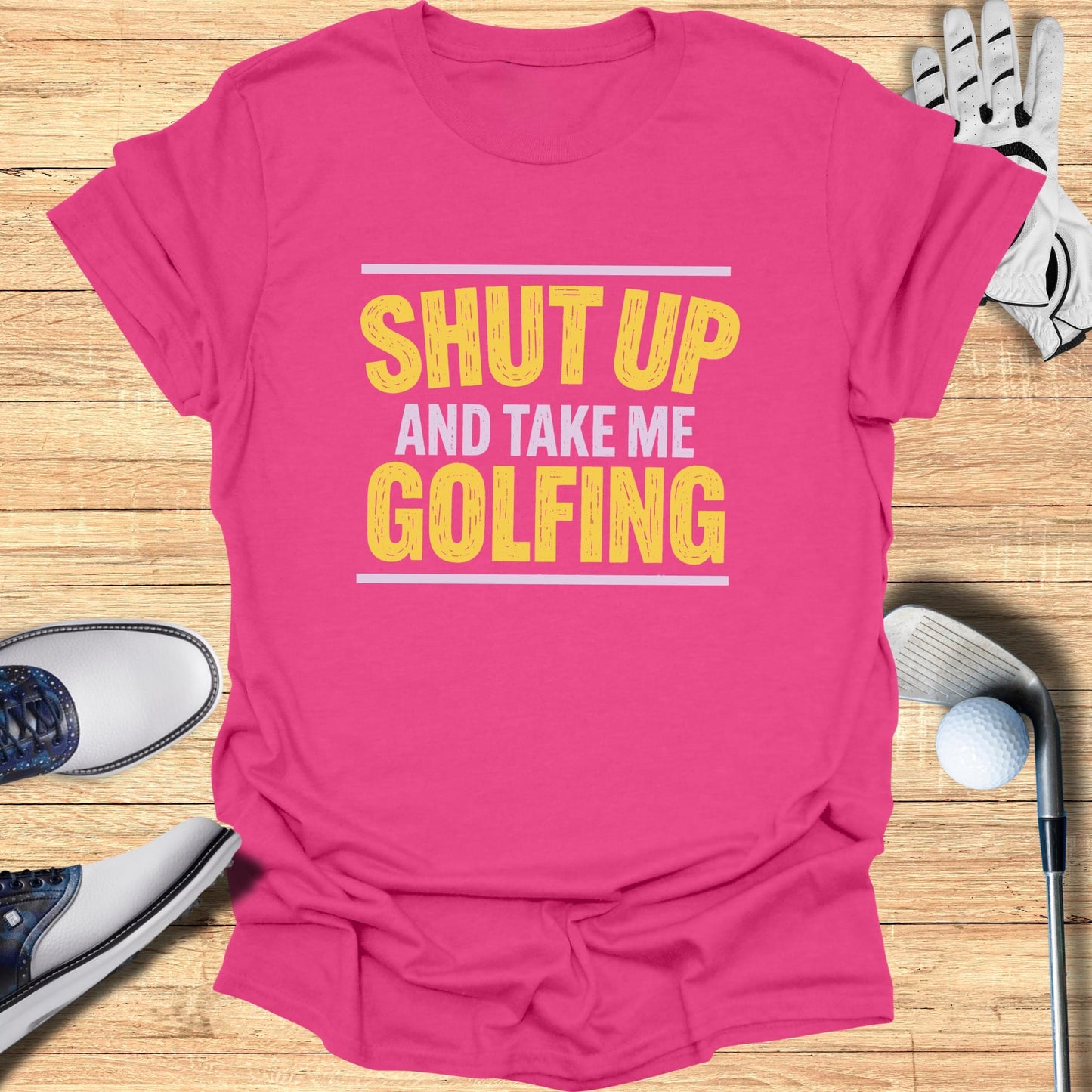 Pink t-shirt with "Shut up and take me golfing" text.