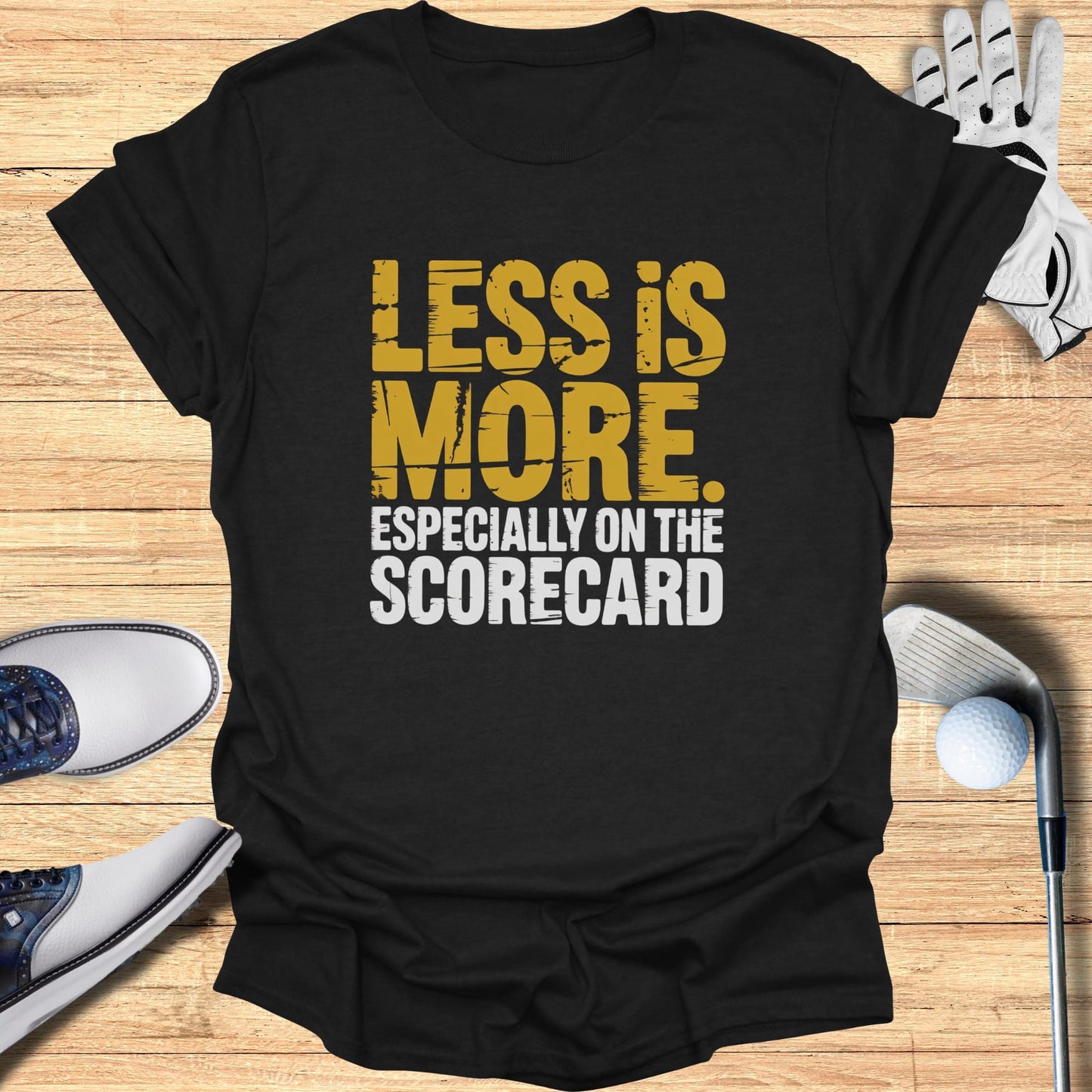 T-shirt with "LESS IS MORE ESPECIALLY ON THE SCORECARD" text.