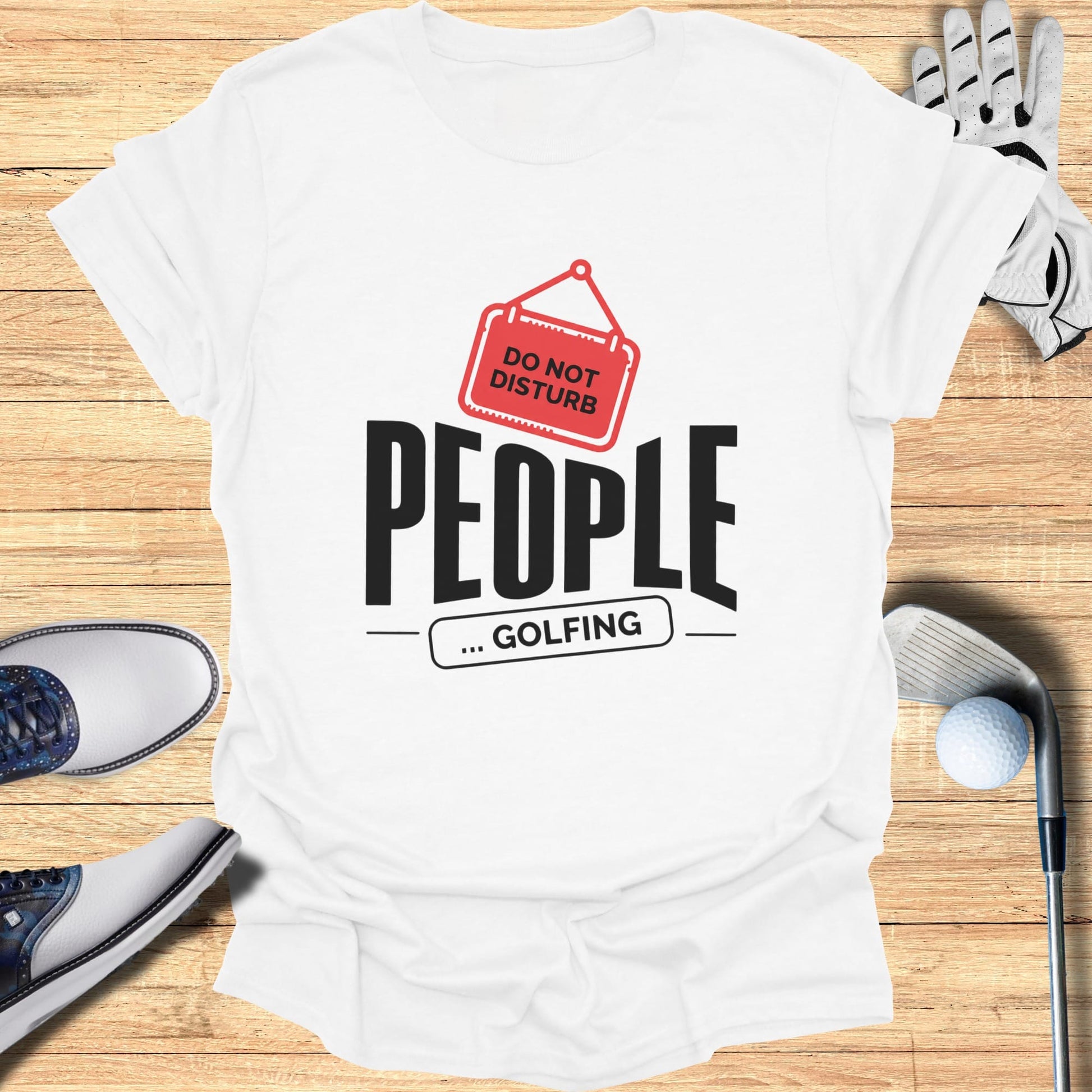 White t-shirt with "DO NOT DISTURB ... GOLFING" text, golf clubs, and shoes.