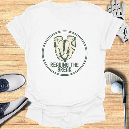 Golf gloves holding a golf ball with "READING THE BREAK" text.