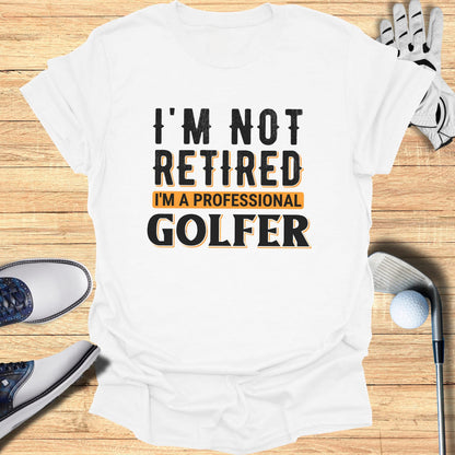 White t-shirt with "I'M NOT RETIRED I'M A PROFESSIONAL GOLFER" text.