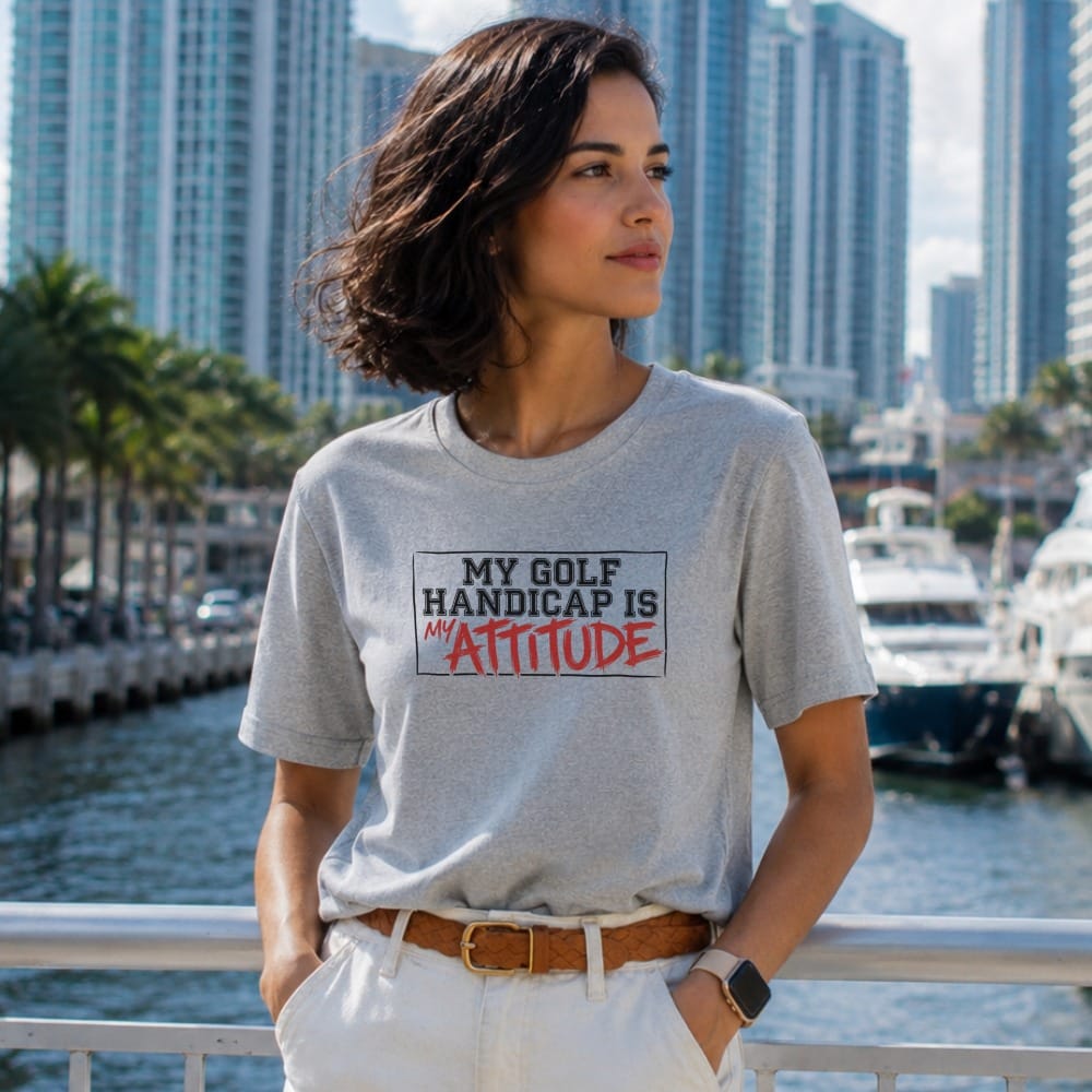 Woman wearing gray t-shirt with "MY GOLF HANDICAP IS MY ATTITUDE" text.