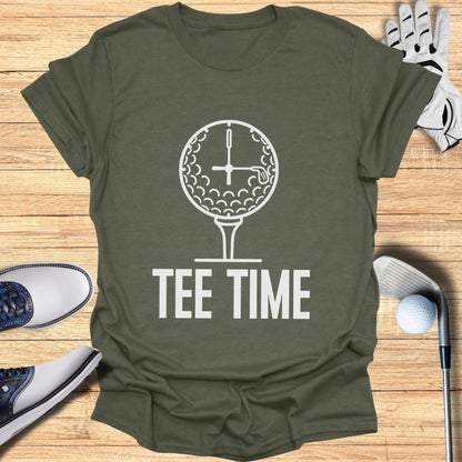 Golf ball clock and tee with "TEE TIME" text on olive green t-shirt.