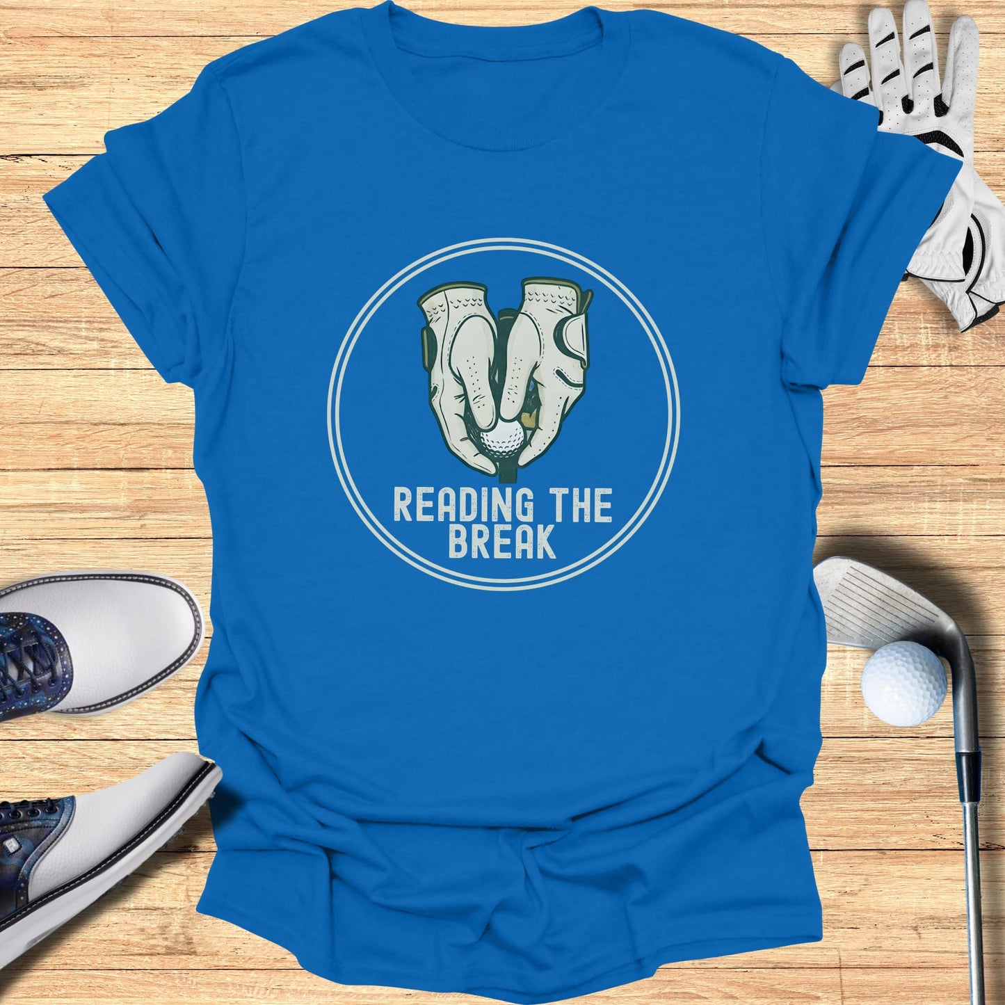 Blue t-shirt with "Reading the Break" text and golf glove graphic.