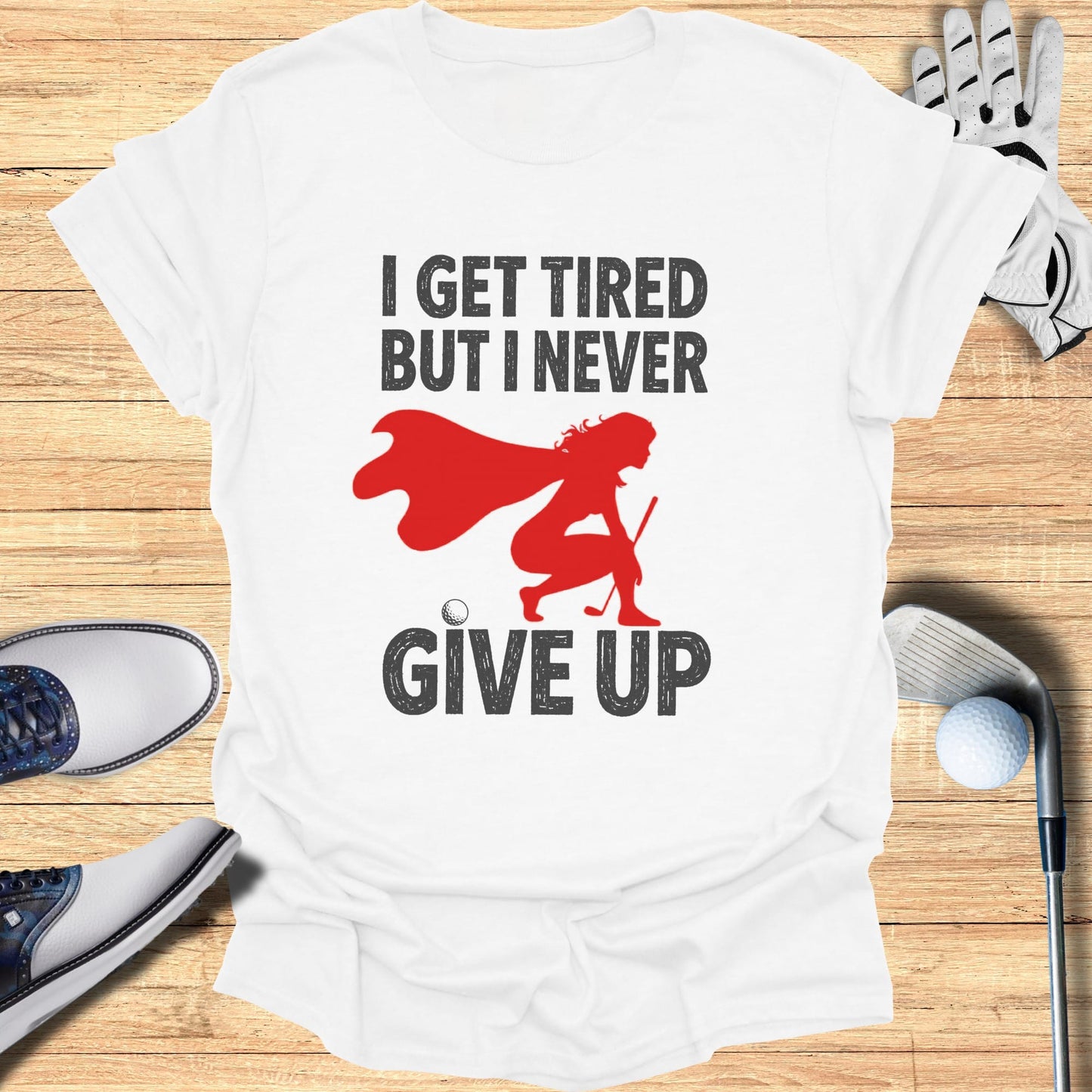 T-shirt with "I GET TIRED BUT I NEVER GIVE UP" and a golfer graphic.