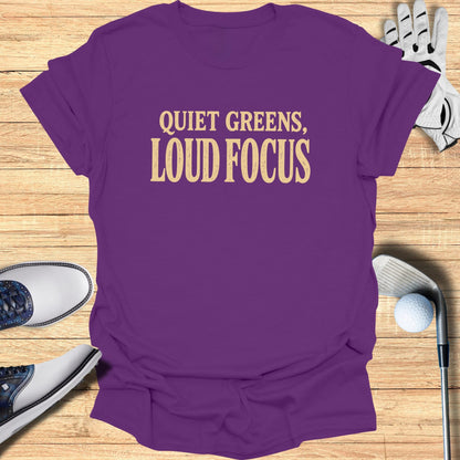 Purple t-shirt with "Quiet Greens, Loud Focus" text, golf shoes, glove, and ball.
