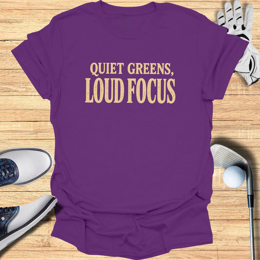 Purple t-shirt with "Quiet Greens, Loud Focus" text, golf shoes, glove, and ball.