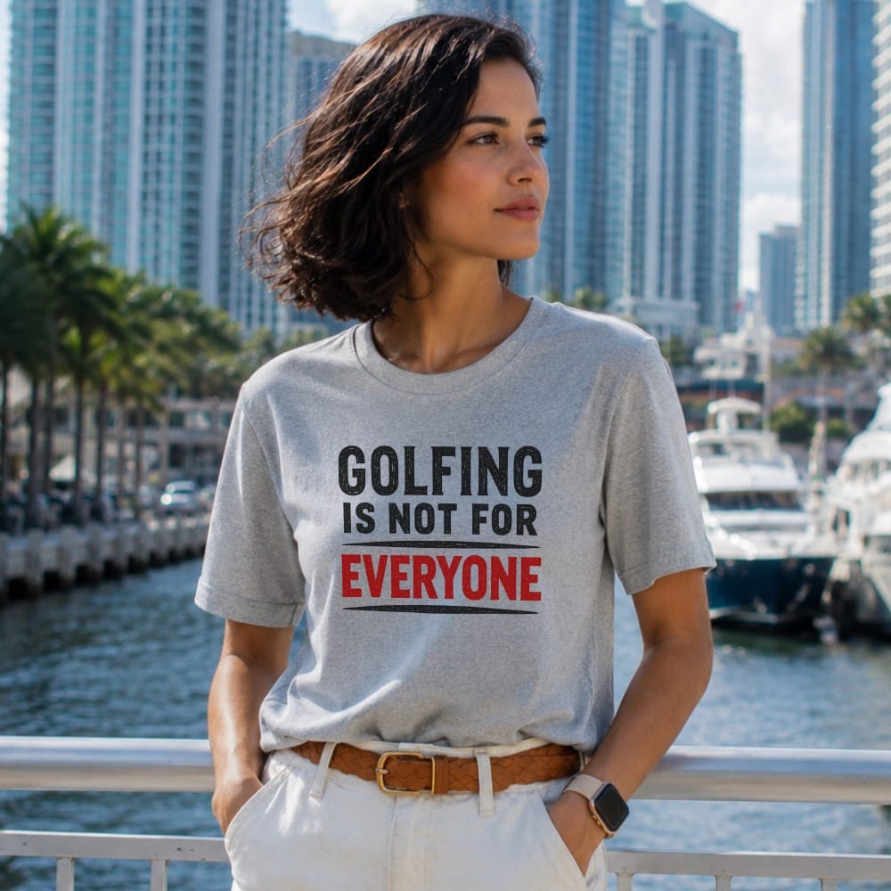 Woman wearing a gray t-shirt with text "GOLFING IS NOT FOR EVERYONE".