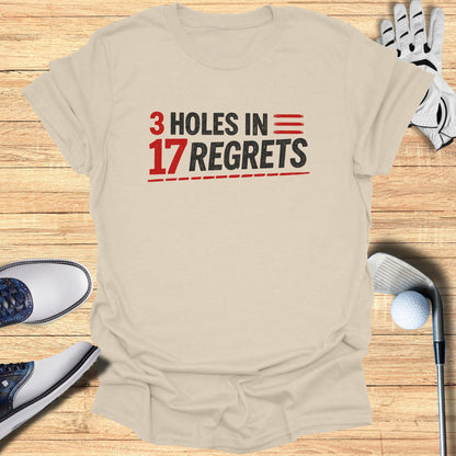 T-shirt with "3 Holes in 17 Regrets" text, golf club, glove, and shoes.