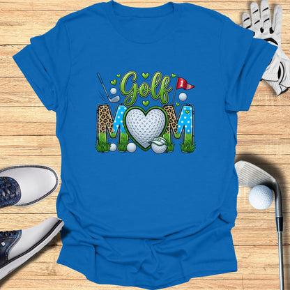 Blue t-shirt with "Golf Mom" text and heart graphic, golf accessories surround.