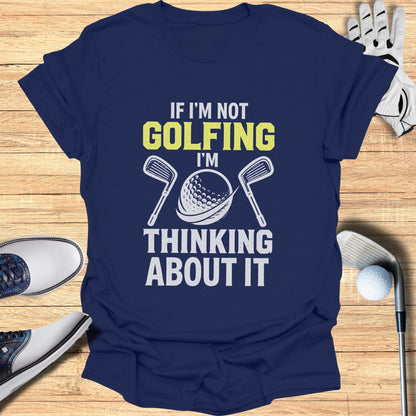 Navy t-shirt with "If I'm Not Golfing, I'm Thinking About It" graphic.