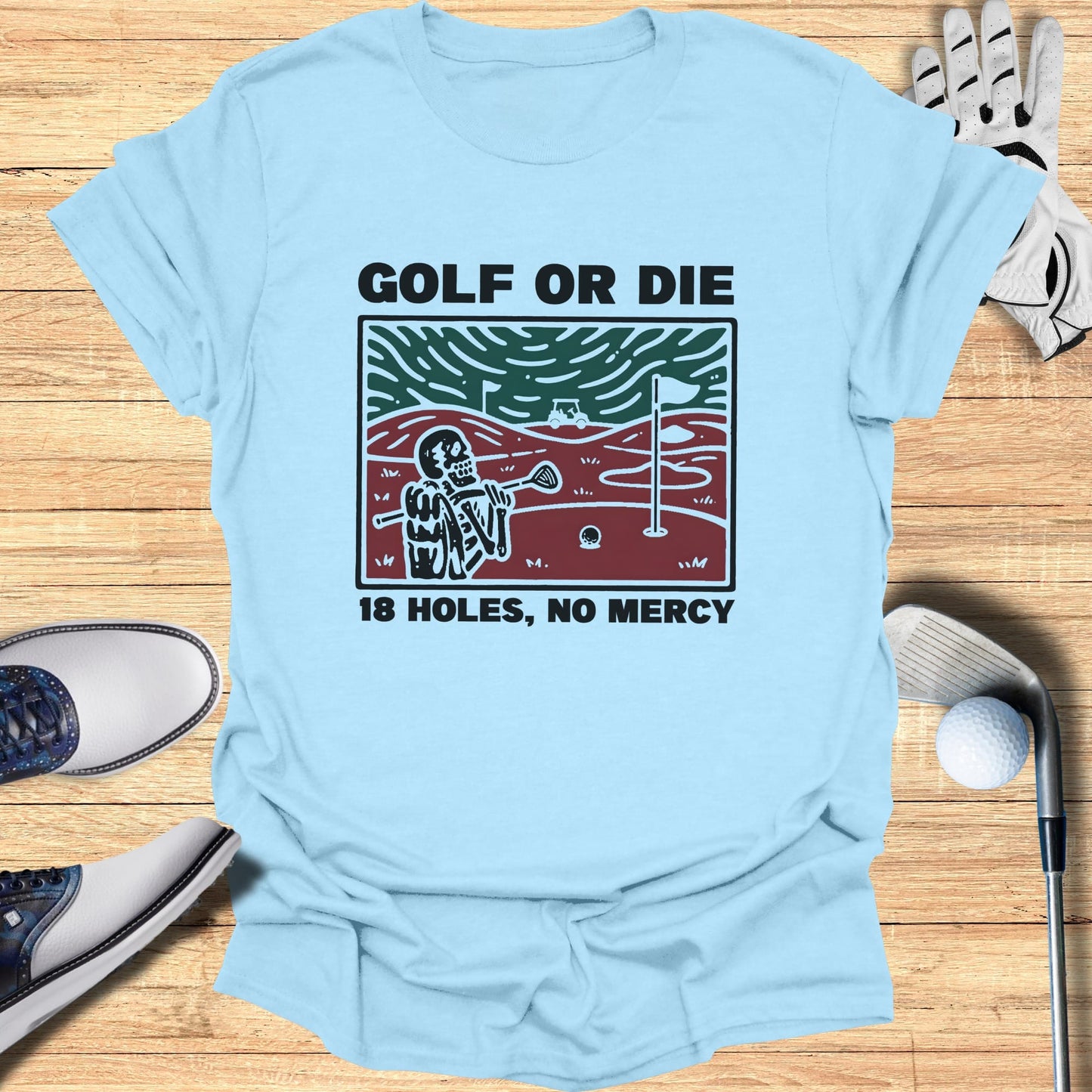 Light blue t-shirt with "Golf or Die 18 Holes, No Mercy" text and skeleton graphic.