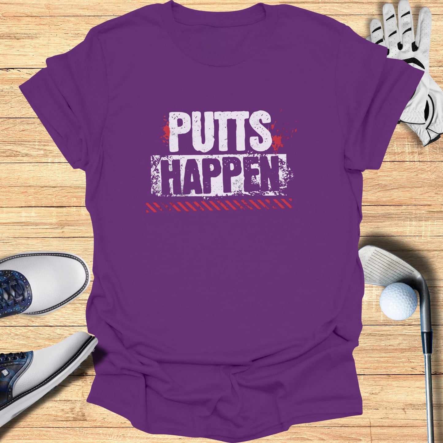 Purple t-shirt with "PUTTS HAPPEN" text in white and red distressed lettering.