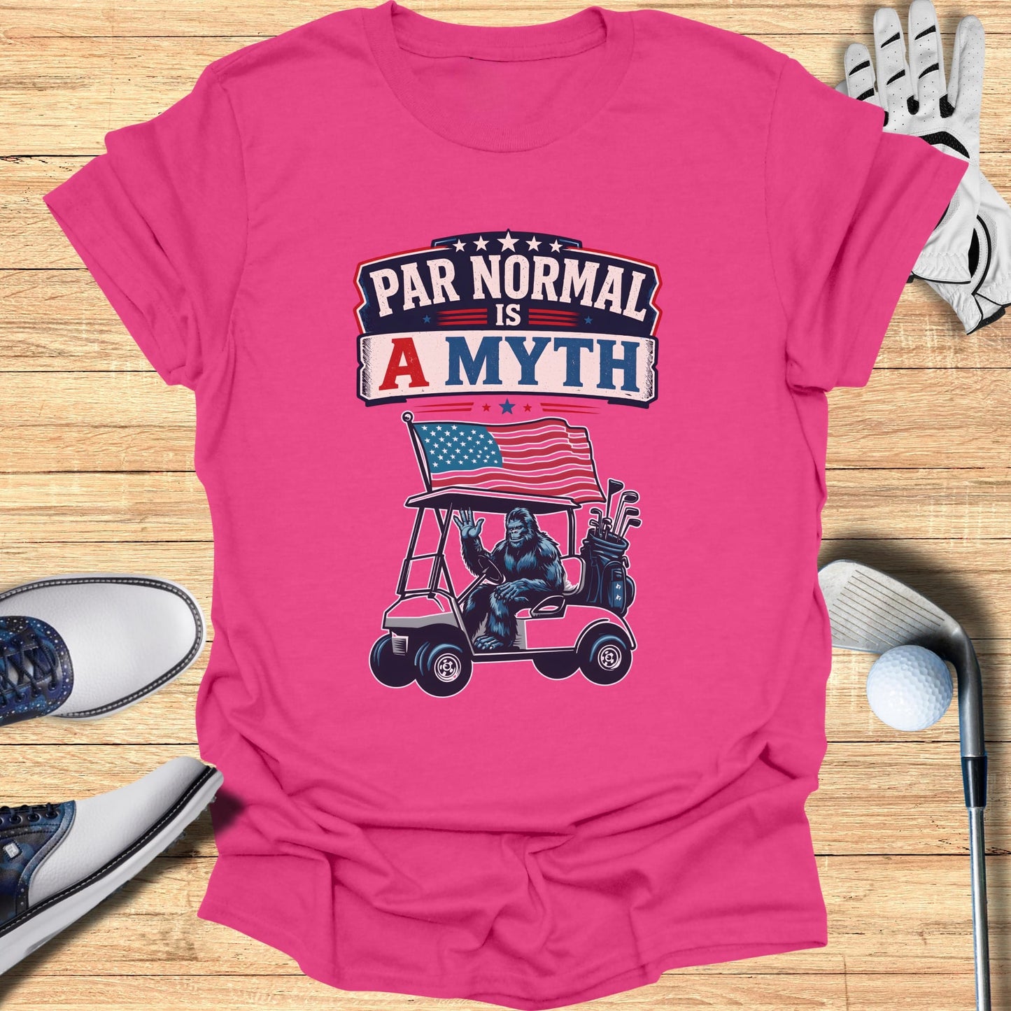 Pink t-shirt with graphic of gorilla in golf cart, "Par Normal is a Myth" text.