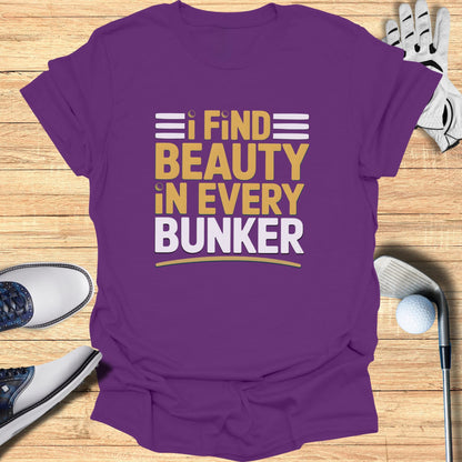 Purple t-shirt with yellow and white text "I FIND BEAUTY IN EVERY BUNKER".
