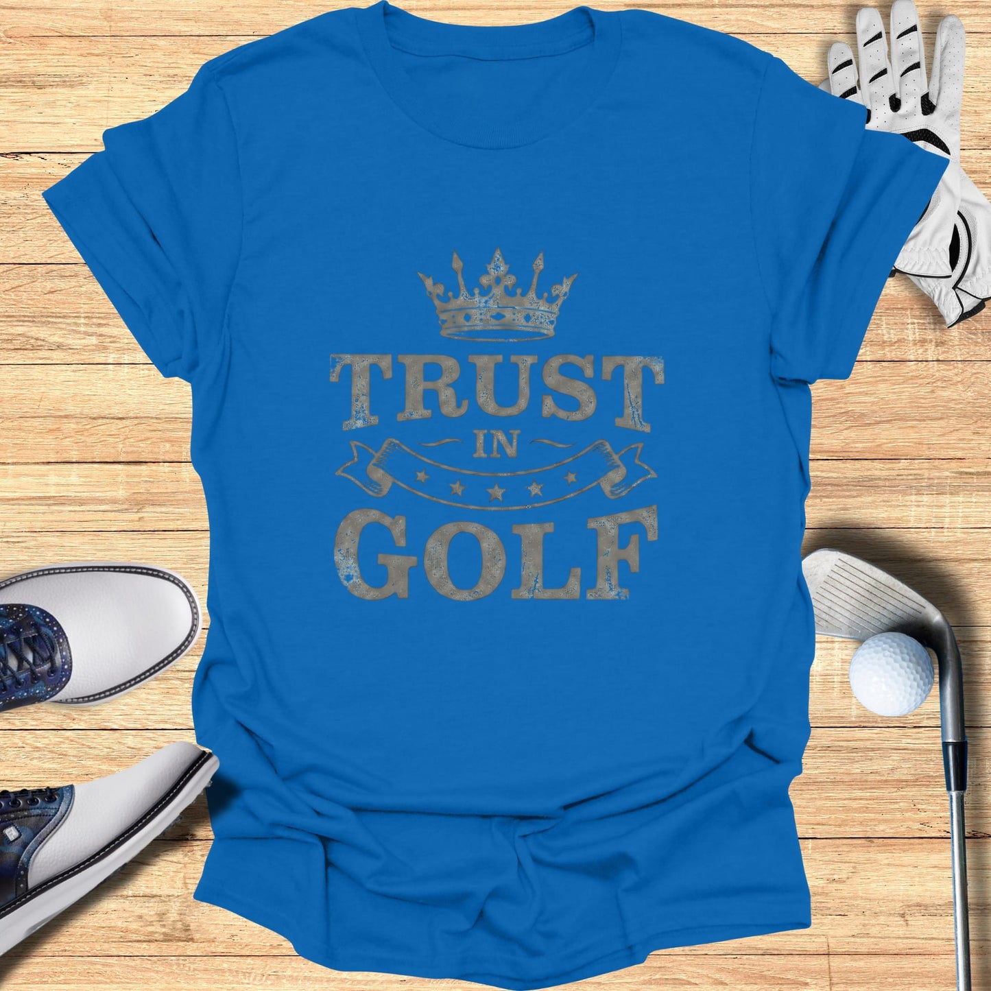 Blue t-shirt with "Trust in Golf" text and crown graphic.