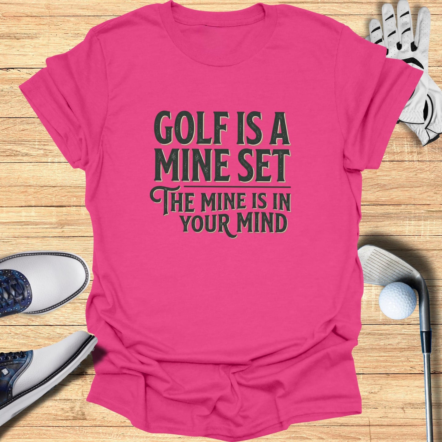 Pink t-shirt with "Golf is a mine set. The mine is in your mind" text.