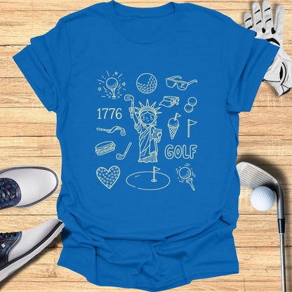 Blue t-shirt with line drawings of golf and patriotic items, including the Statue of Liberty.
