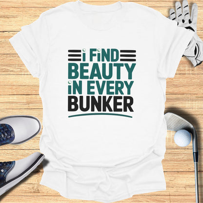 White t-shirt with "I find beauty in every bunker" slogan.