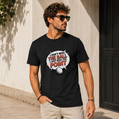 Black t-shirt with "I don't miss the ball I just miss the point" and golf ball graphic.