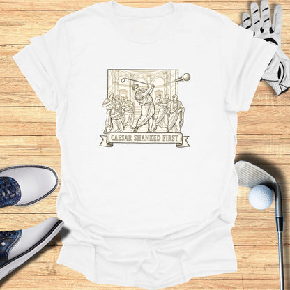 T-shirt with illustration of Roman figures playing golf, "CAESAR SHANKED FIRST" text.