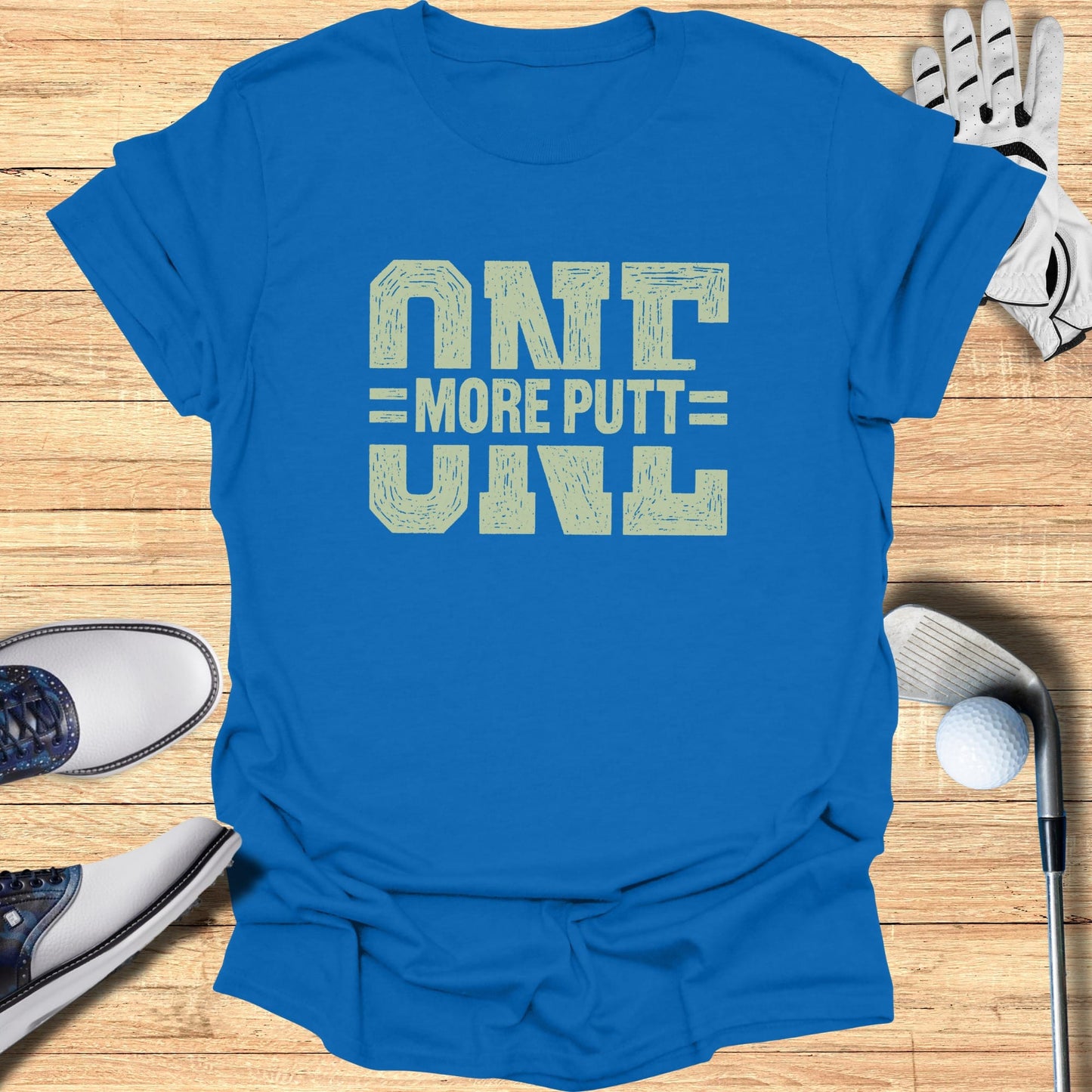 Blue t-shirt with "ONE MORE PUTT" in distressed yellow text.