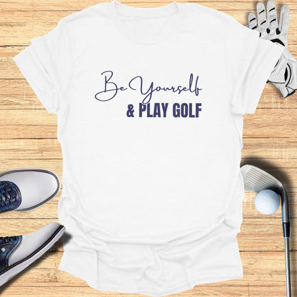 White t-shirt with "Be Yourself & Play Golf" text, golf shoes, and club.