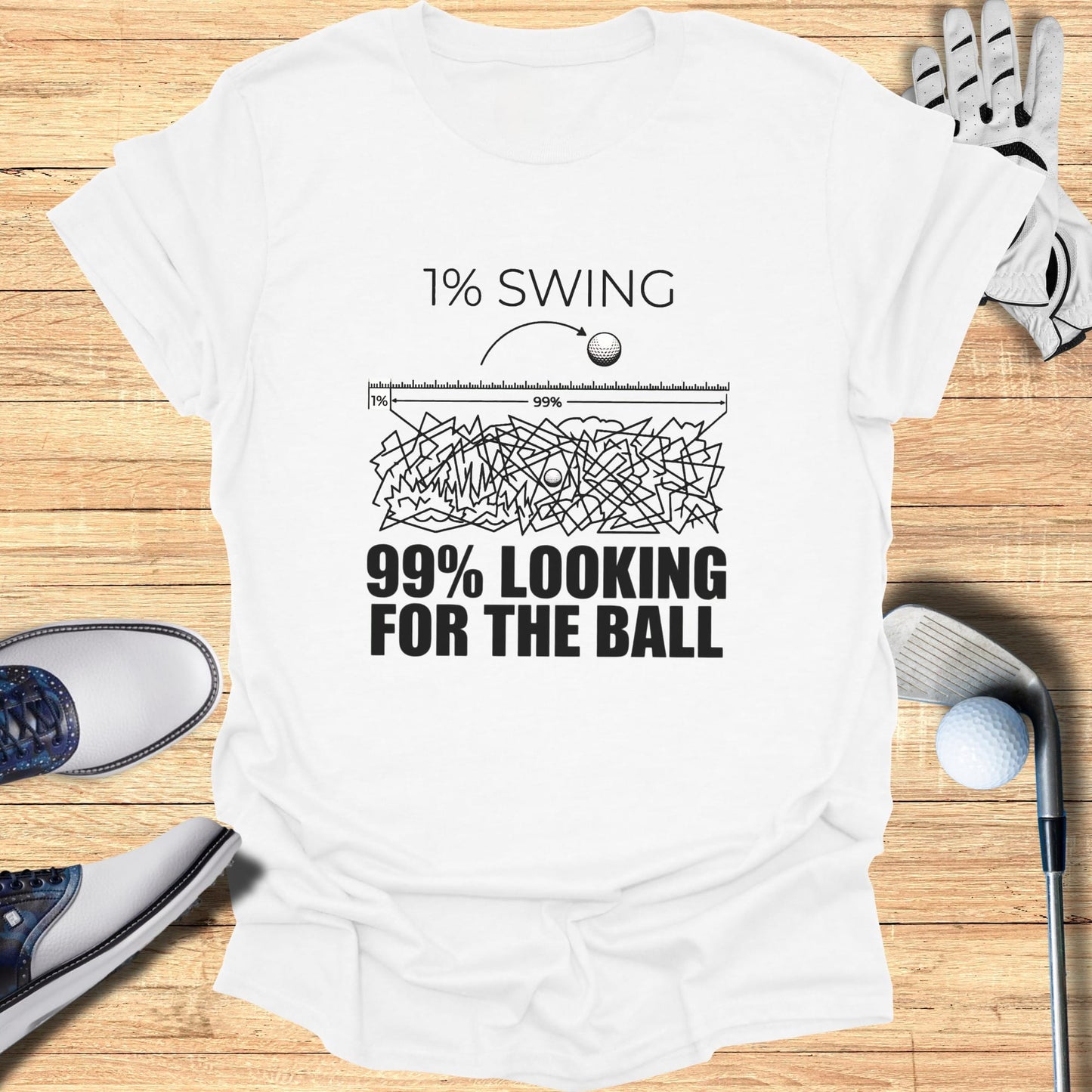 White t-shirt with graphic of a golf ball and text "1% SWING 99% LOOKING FOR THE BALL".
