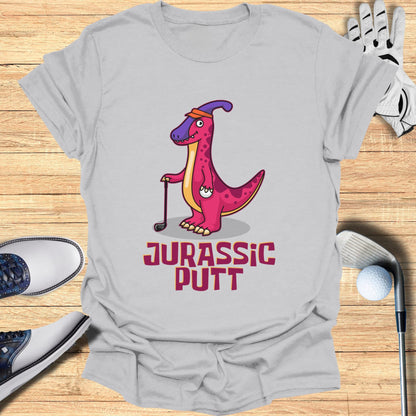 Pink cartoon dinosaur holding a golf club with "Jurassic Putt" text.