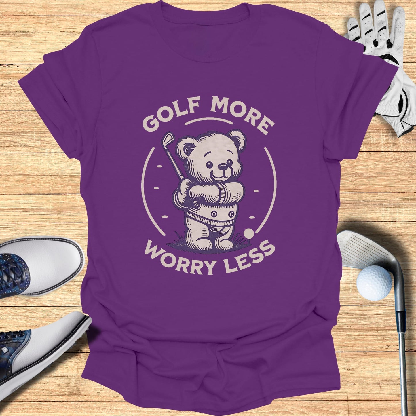Purple t-shirt with a cartoon bear playing golf and text "Golf More Worry Less".