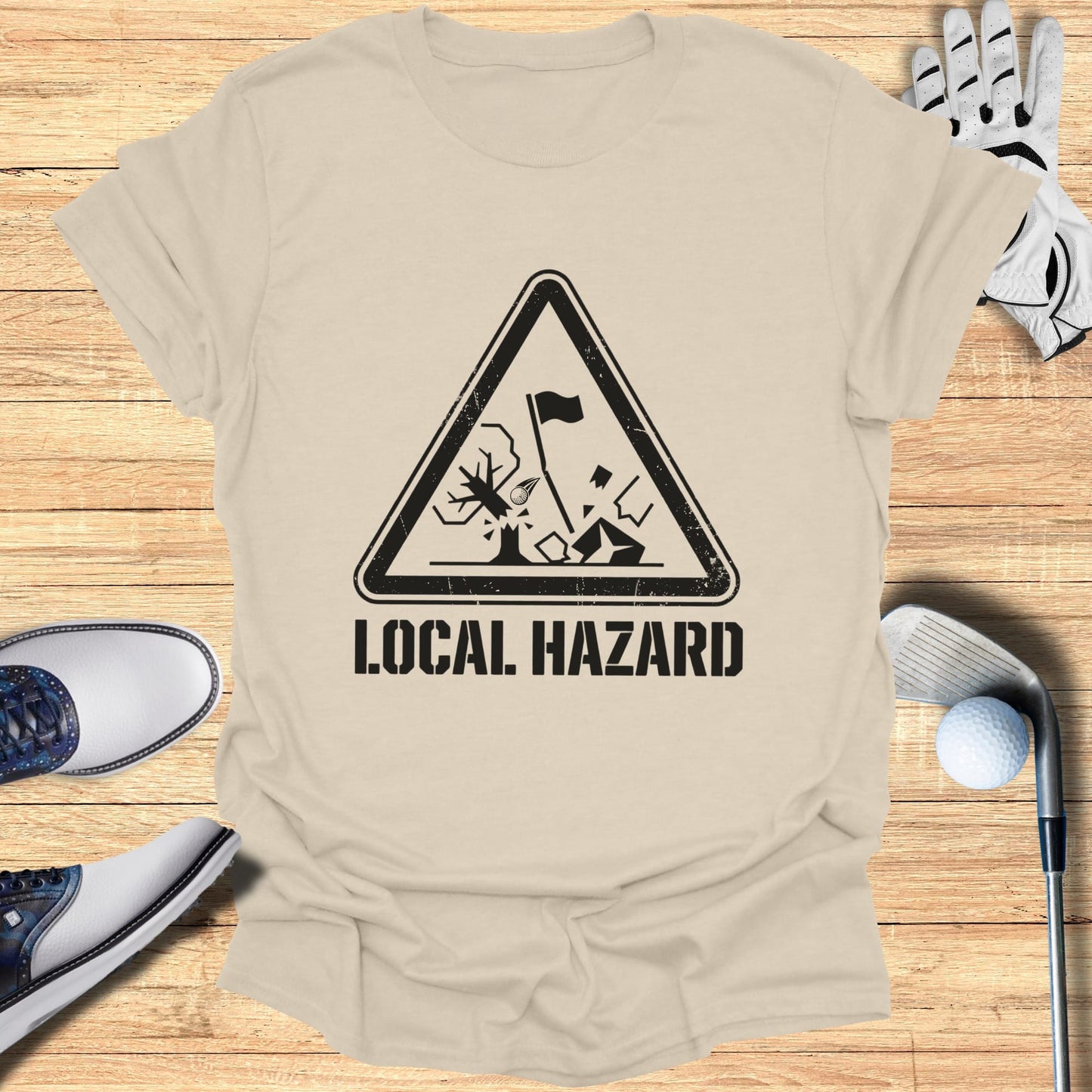 T-shirt with a black triangle hazard symbol depicting a golf hazard.