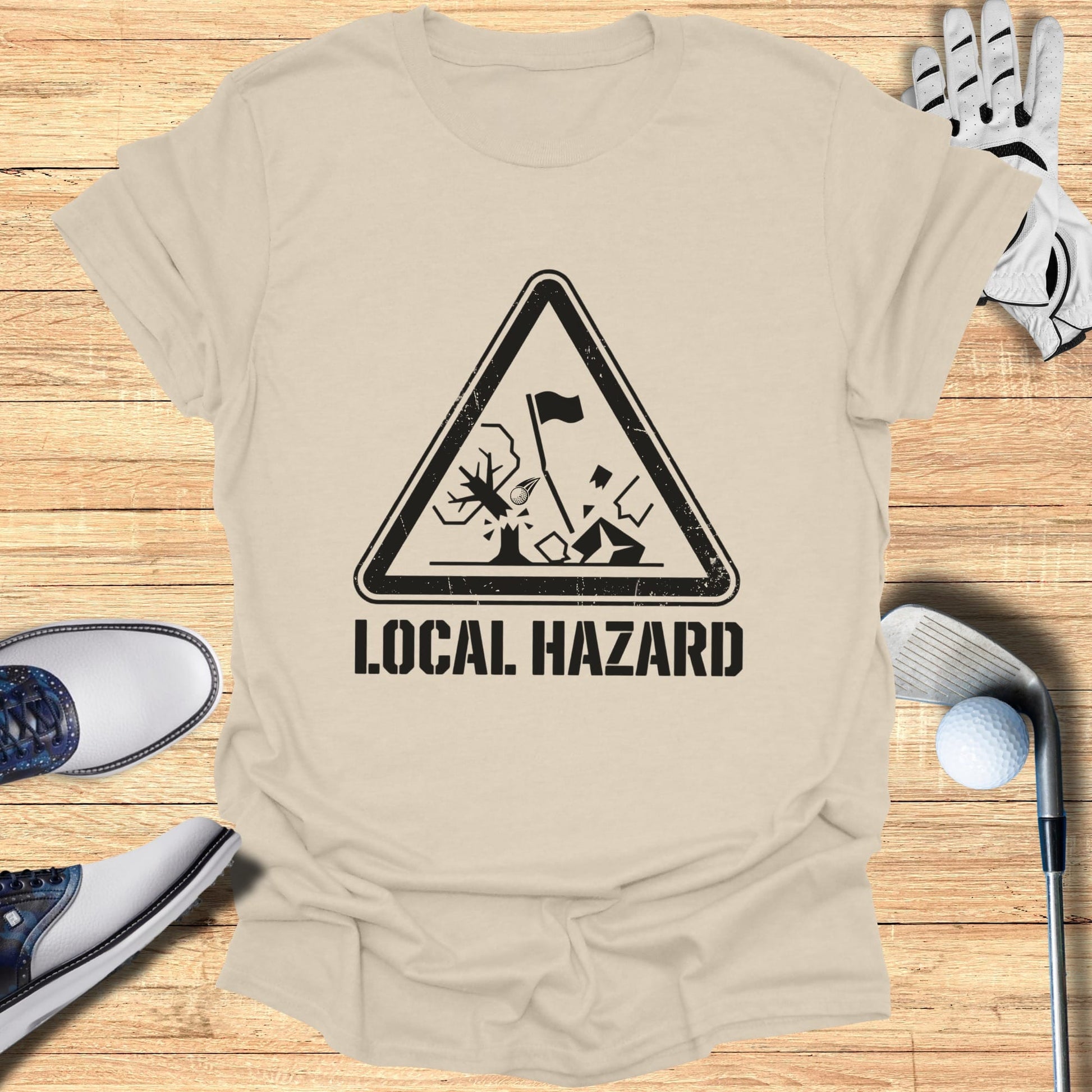 T-shirt with a black triangle hazard symbol depicting a golf hazard.