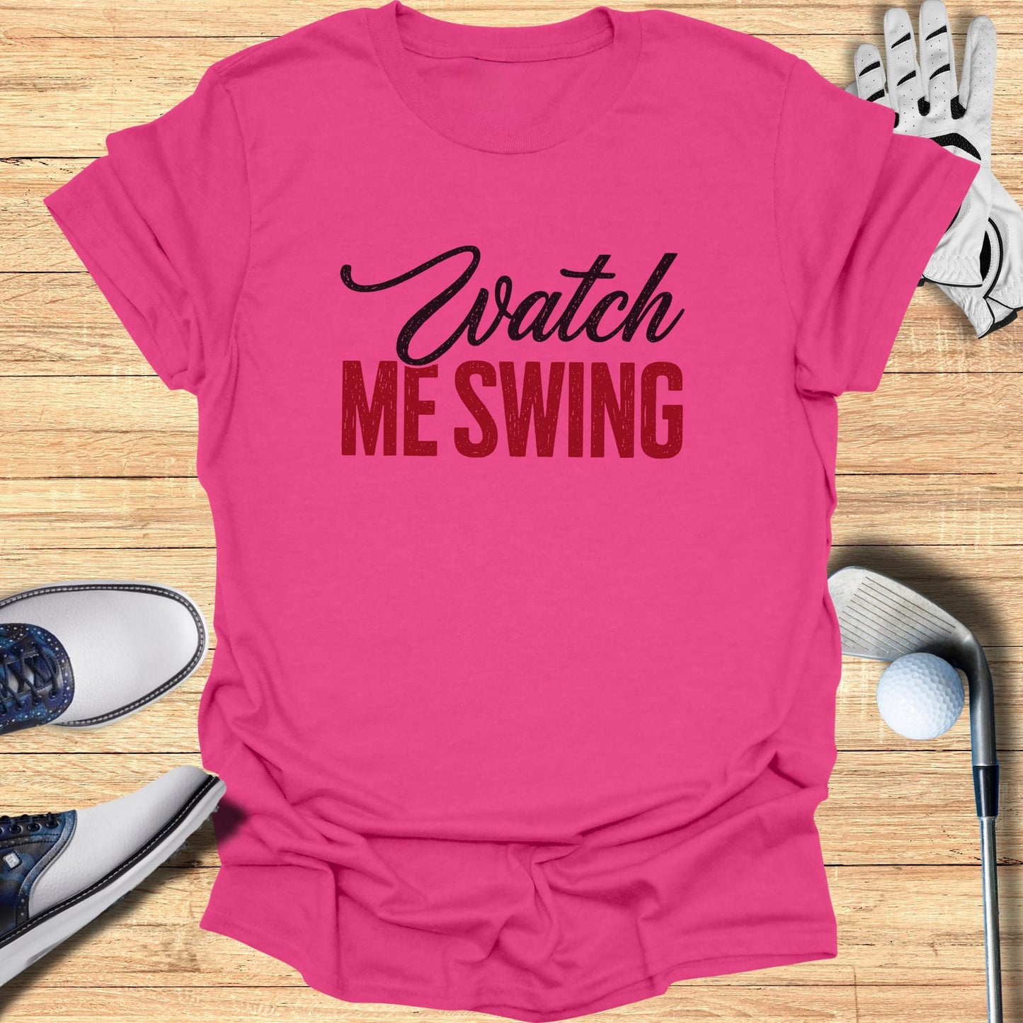 Pink t-shirt with "Watch Me Swing" in black and red text.