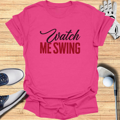 Pink t-shirt with "Watch Me Swing" in black and red text.
