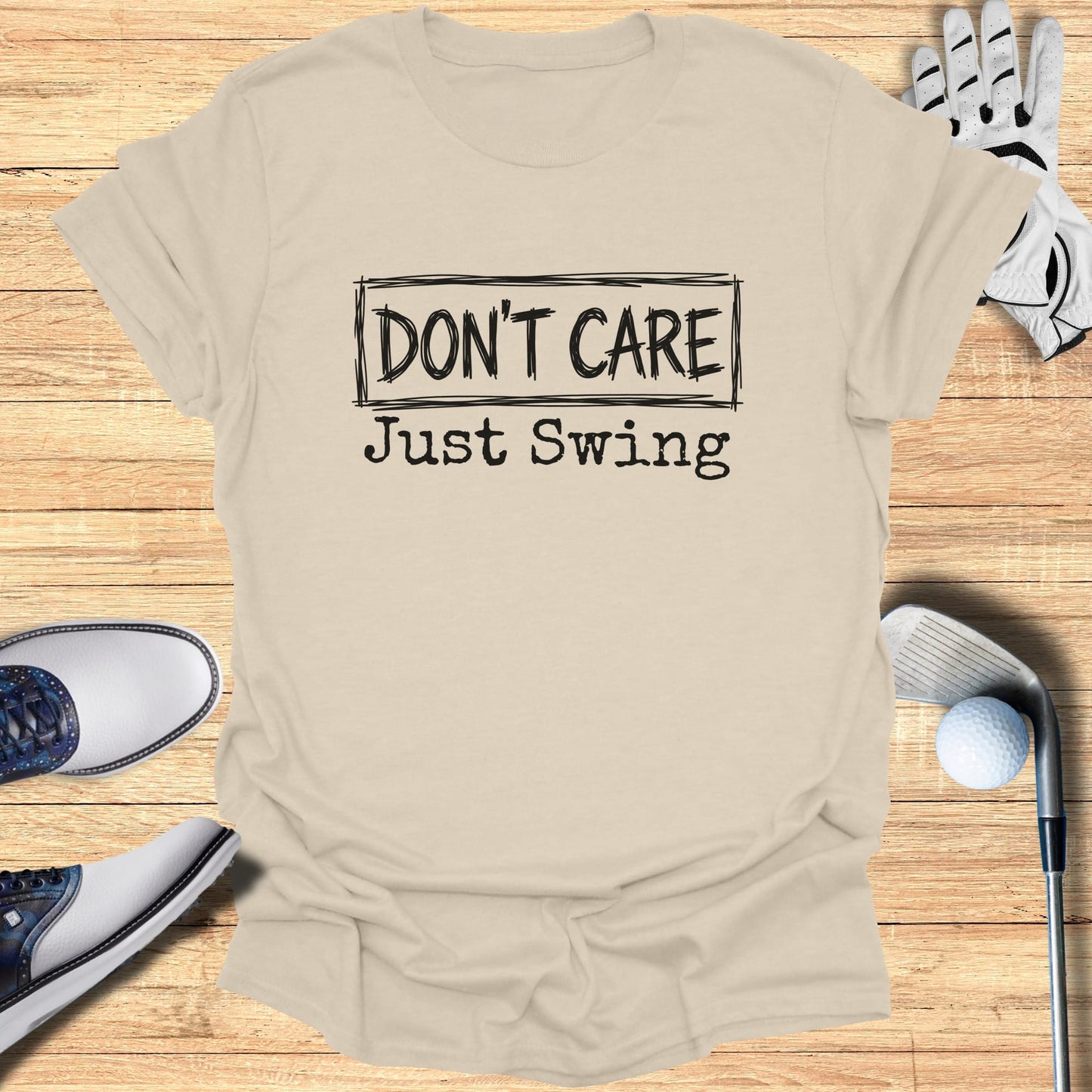 Beige t-shirt with "DON'T CARE Just Swing" text, golf clubs, shoes, and glove.