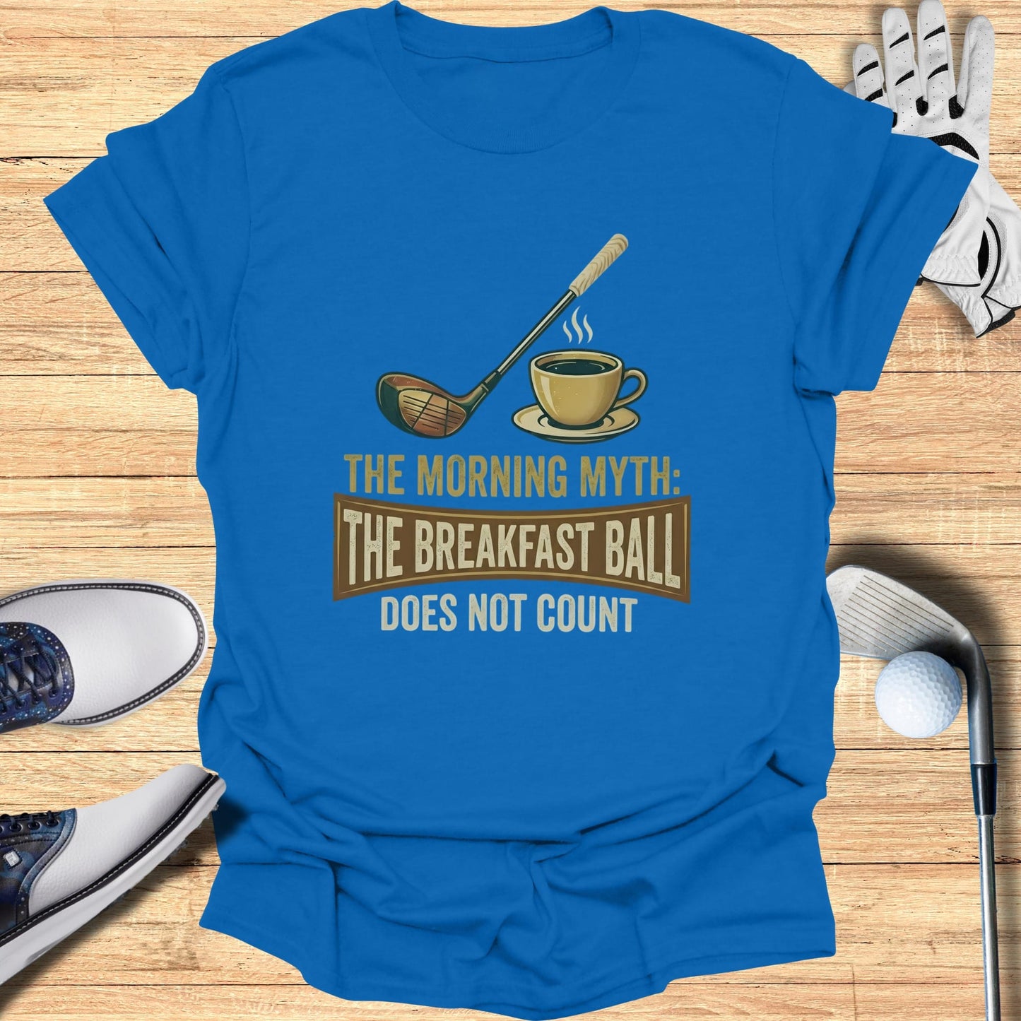Blue t-shirt with golf club and coffee mug graphic reading "The Morning Myth: Does Not Count".